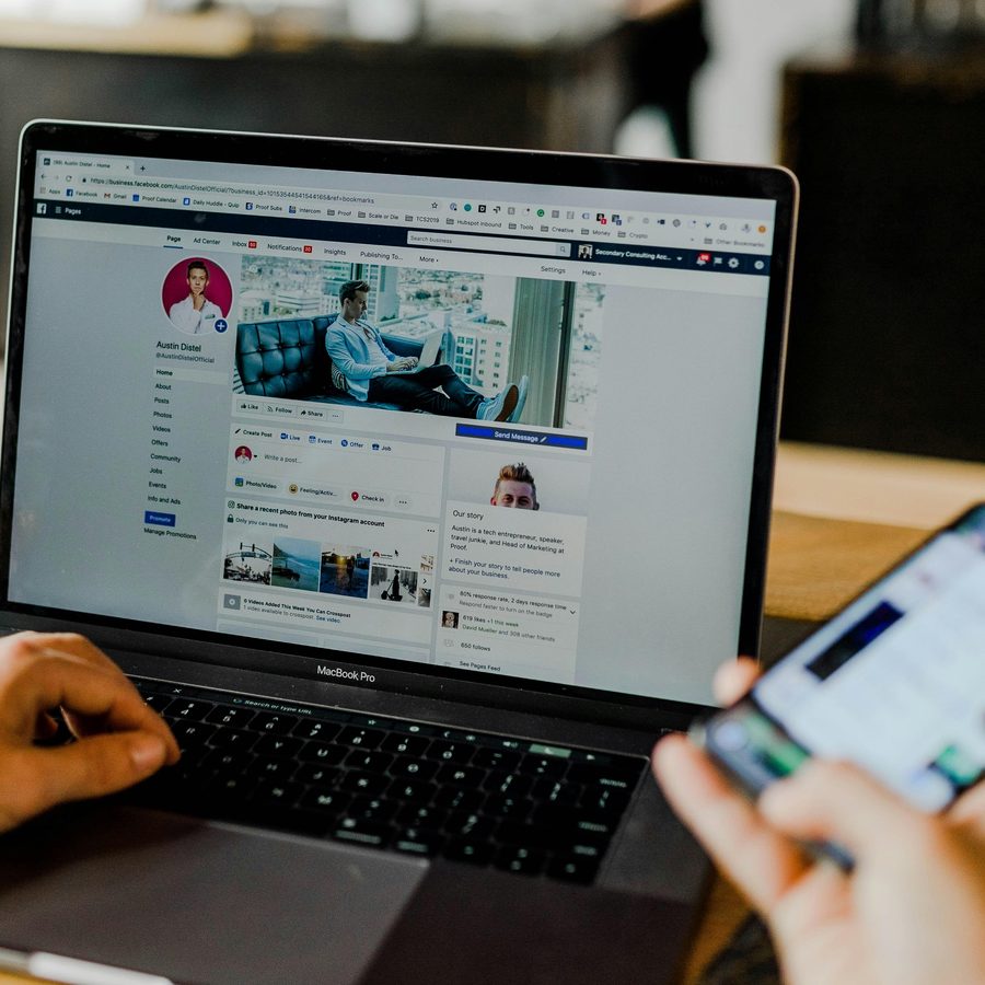 Laptop and phone open on a social feed